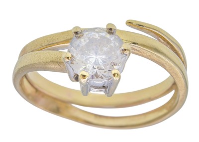 Lot 18 - A gold and zircon set coiled ring.