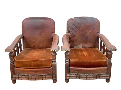 Lot 501 - A pair of leather fireside chairs.