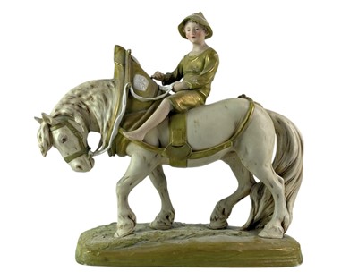 Lot 335 - A Royal Dux figure of a boy riding a horse.