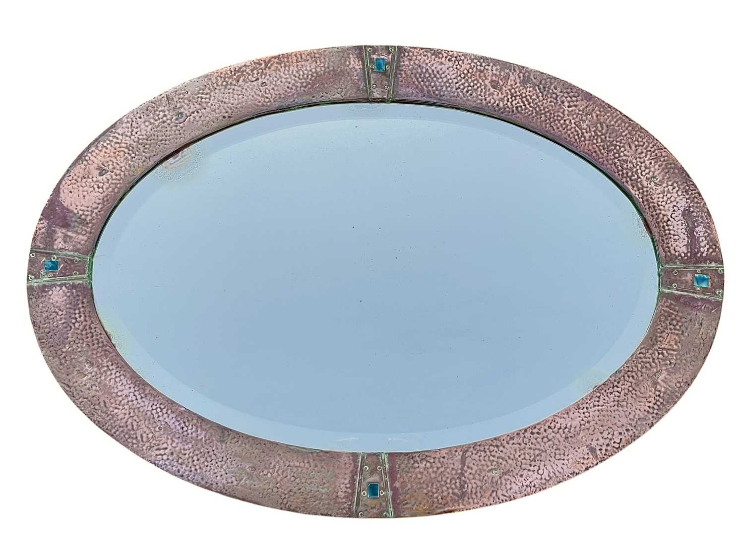 Lot 487 - An Arts and Crafts oval copper mirror.