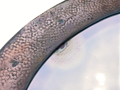 Lot 487 - An Arts and Crafts oval copper mirror.