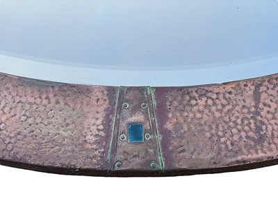 Lot 487 - An Arts and Crafts oval copper mirror.