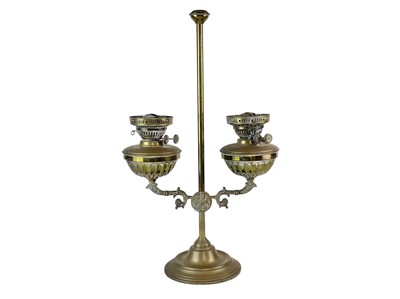 Lot 120 - A brass twin branch adjustable oil lamp.
