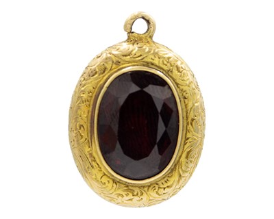 Lot 111 - A Victorian high-purity gold garnet memorial locket pendant.