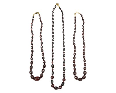 Lot 212 - Three faceted cherry amber style bead necklaces.