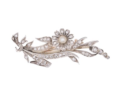 Lot 97 - An attractive high-purity gold with silver, diamond, and pearl set flower brooch.