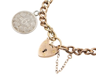 Lot 85 - A 9k rose gold curb link bracelet with a heart-shaped clasp.