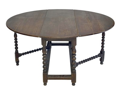 Lot 900b - An oak gateleg dining table.