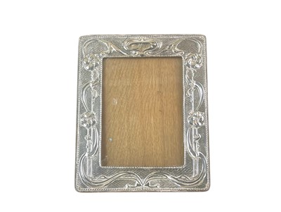 Lot 241 - An Edwardian Art Nouveau silver easel photograph frame of rectangular form.