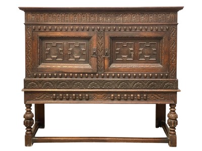 Lot 536 - A 17th century style oak cupboard on stand, in the Arts and Crafts taste.