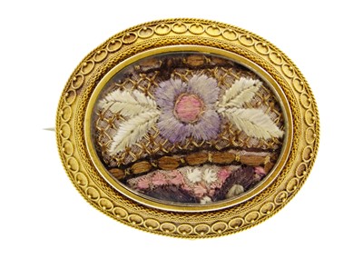 Lot 159 - A Victorian 14k gold (tested) Etruscan Revival oval locket brooch.