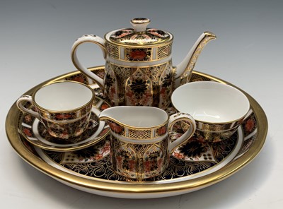 Lot 853 - A Royal Crown Derby miniature tea-for-one set...