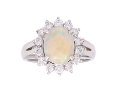 Lot 105 - A platinum , opal and diamond set halo ring.