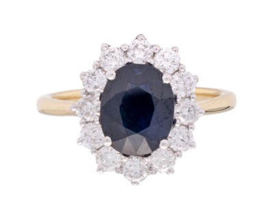 Lot 115 - An 18k gold sapphire and diamond set cluster ring.