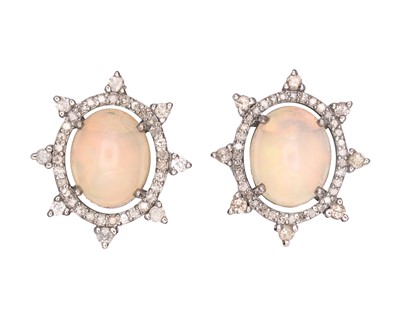 Lot 117 - A pair of silver sunburst stud earrings set with oval cabochon opals and diamonds.