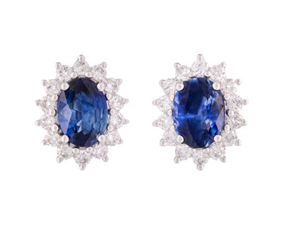 Lot 119 - A pair of 18k white gold sapphire and diamond set cluster stud earrings.