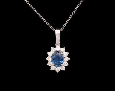 Lot 124 - An 18k gold sapphire and diamond pendant on 18k gold fine cable chain necklace.