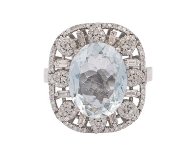 Lot 139 - An ornate silver aquamarine and diamonds set dress ring.