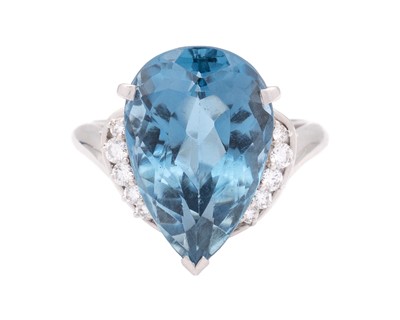 Lot 144 - A large Swiss blue topaz and diamond set dress ring in platinum.