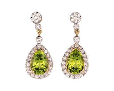 Lot 146 - A pair of 18k gold peridot and diamond set pendant earrings.