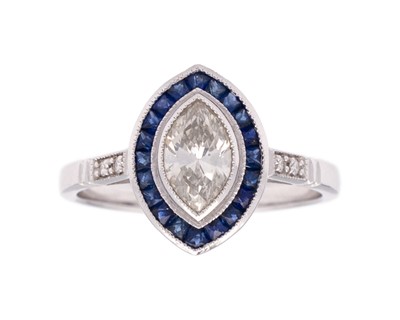 Lot 153 - An 18k white gold diamond and sapphire navette-shaped ring.