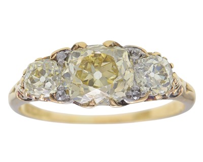Lot 202 - An 18k gold three-stone fancy yellow diamond ring.
