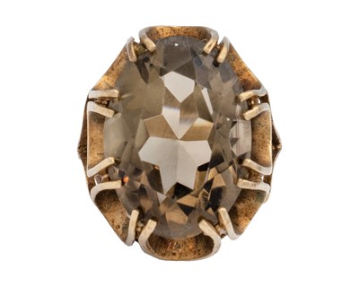 Lot 196 - A 9k gold smokey quartz dress ring.