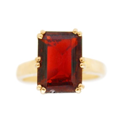 Lot 191 - A 9k gold garnet set dress ring.