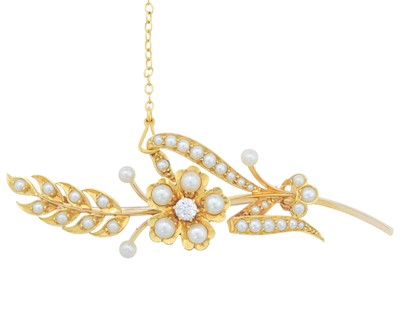 Lot 145 - An Edwardian 15k gold seed pearl and diamond set floral brooch.