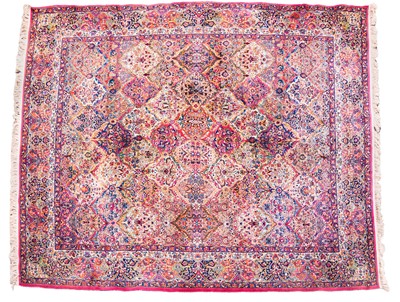 Lot 675 - A large Kirman carpet.