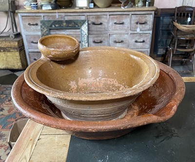 Lot 152 - A small terracotta pancheon with an attached strainer.