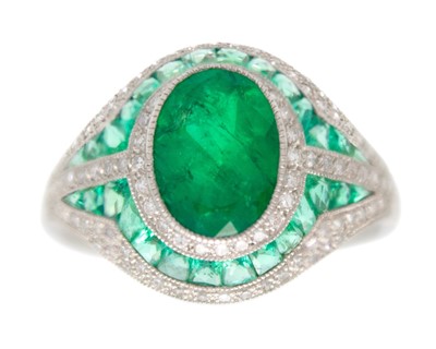 Lot 68 - An Art Deco-style emerald and diamond dress ring set in platinum.