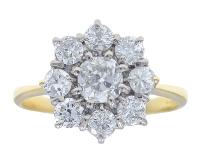 Lot 75 - An attractive 18k gold diamond set daisy ring.