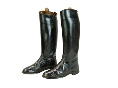 Lot 31 - A pair of black leather riding boots and trees.
