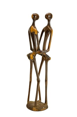 Lot 34 - An East African carved ebony or lignum vitae figure group.