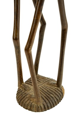Lot 34 - An East African carved ebony or lignum vitae figure group.