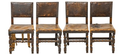Lot 986 - A set of four Cromwellian style oak and leather upholstered dining chairs.