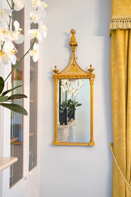 Lot 522 - A pair of giltwood and verre eglomise mirrors or pier glasses.