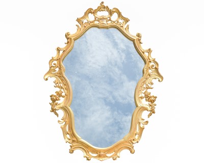 Lot 502 - A carved giltwood rococo style wall mirror.