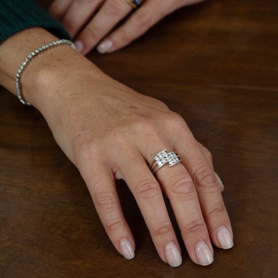 Lot 104 - A 14k white gold and diamond dress ring.
