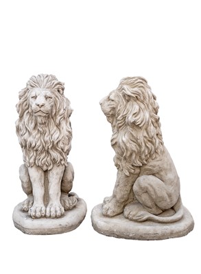 Lot 874 - A pair of cast stone sculptures of seated lions.