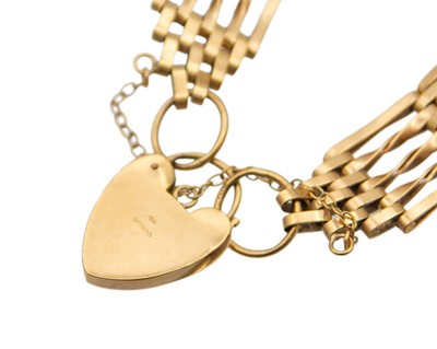 Lot 21 - A 9k gold gate link bracelet fitted with a padlock.