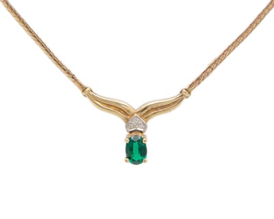 Lot 71 - A 10k gold, synthetic emerald, and diamond necklace.