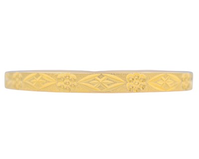 Lot 5 - A 21k gold engraved design bangle.