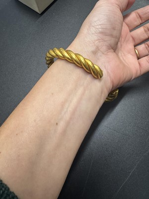 Lot 31 - A high-purity gold hollow twist bangle.