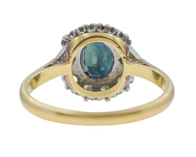Lot 7 - An 18k gold teal sapphire and diamond cluster ring.