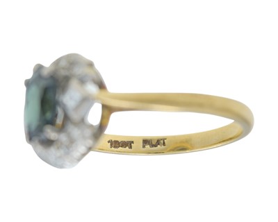 Lot 7 - An 18k gold teal sapphire and diamond cluster ring.