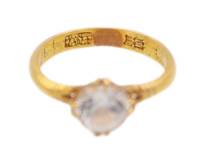 Lot 38 - A high-purity gold and white synthetic sapphire solitaire ring.