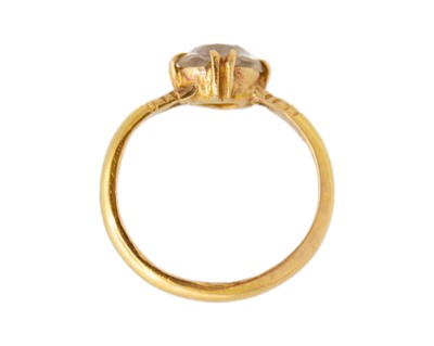 Lot 38 - A high-purity gold and white synthetic sapphire solitaire ring.