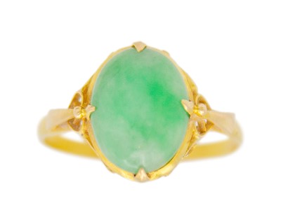 Lot 42 - A 21k gold and jade solitaire ring.